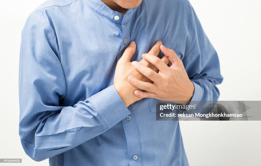 Heart attack concept. Young man suffering from chest pain, close up