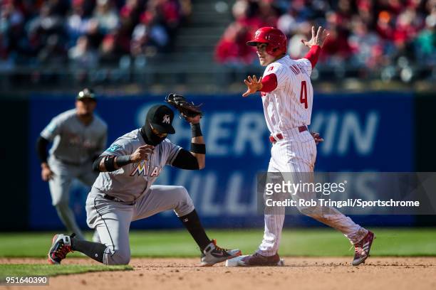 Scott Kingery of the Philadelphia Phillies steals second base before the tag by Starlin Castro of the Miami Marlins during the game at Citizens Bank...