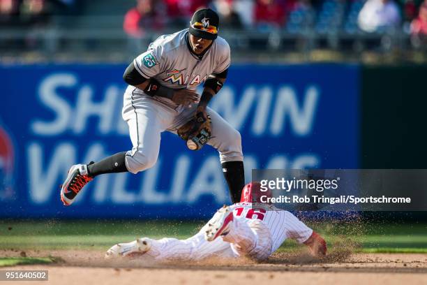 Starlin Castro of the Miami Marlins attempts to make the tag on Cesar Hernandez of the Philadelphia Phillies at Citizens Bank Park on Thursday, April...