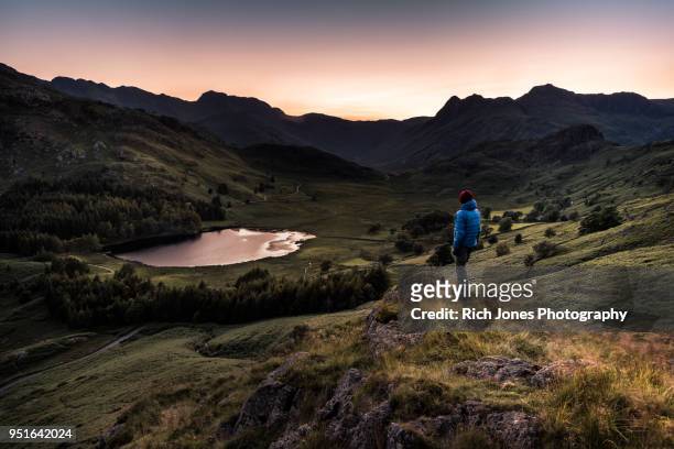 hiker at sunset in the english lake district - british culture walking stock pictures, royalty-free photos & images