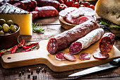 Mixed spanish chorizo pieces on rustic wooden table