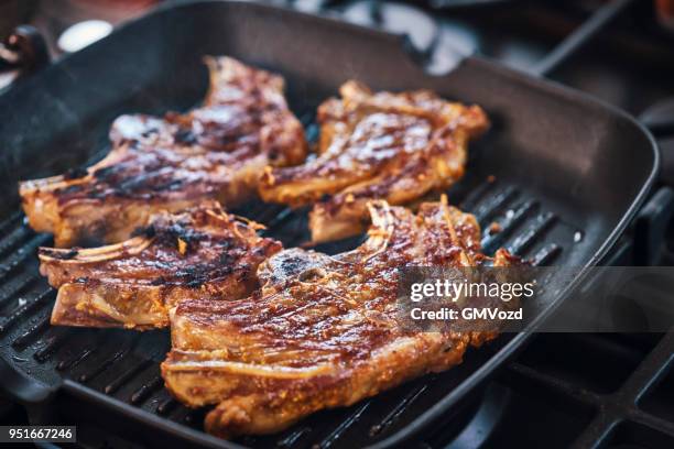 roasting lamb chops in a grill cooking pan - grilled lamb stock pictures, royalty-free photos & images