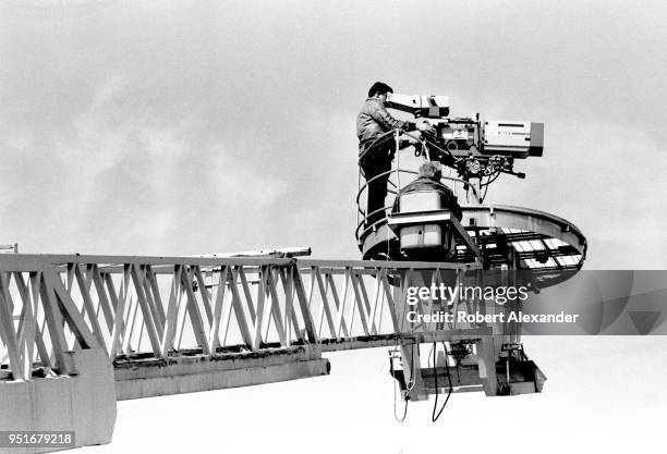 Television cameraman follows the action on the track during the 1983 Daytona 500 stock car race at Daytona International Speedway in Daytona Beach,...