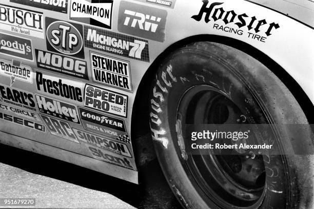 Racecar with Hoosier tires is embelllished with sponsor decals at Daytona International Speedway in Daytona Beach, Florida.