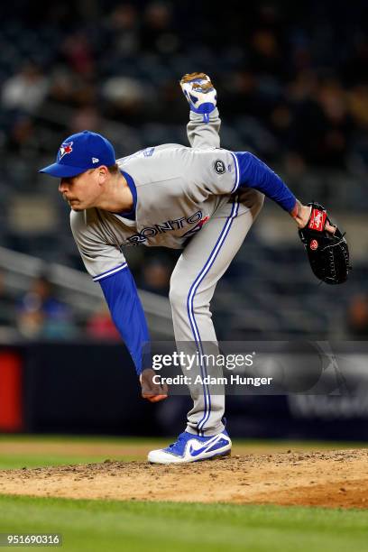 John Axford of the Toronto Blue Jays pitches against the New York Yankees during the eighth inning at Yankee Stadium on April 19, 2018 in the Bronx...