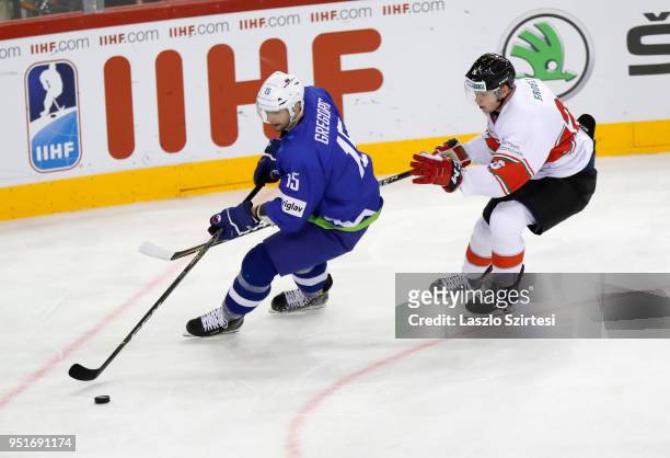 Blaz Gregorc of Slovenia is challenged by Csanad Erdely of Hungary during the 2018 IIHF Ice Hockey World Championship Division I Group A match...