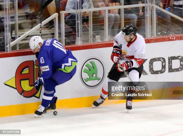 Anze Kuralt of Slovenia and Zsombor Garat of Hungary in action during the 2018 IIHF Ice Hockey World Championship Division I Group A match between...