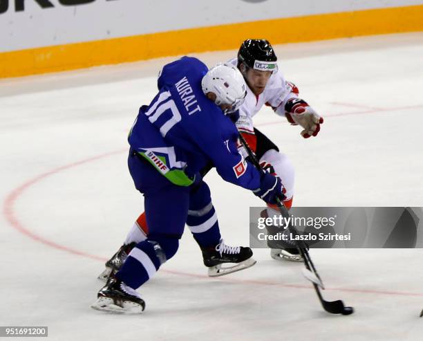 Anze Kuralt of Slovenia and Zsombor Garat of Hungary in action during the 2018 IIHF Ice Hockey World Championship Division I Group A match between...