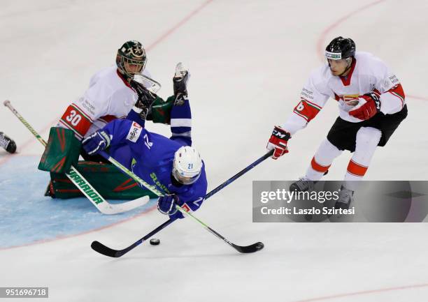 Adam Vay of Hungary, Andrej Hebar of Slovenia and Bence Sziranyi of Hungary in action during the 2018 IIHF Ice Hockey World Championship Division I...