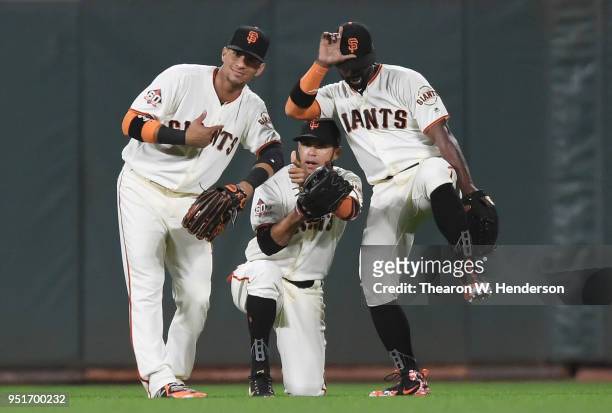 Gorkys Hernandez, Gregor Blanco and Andrew McCutchen of the San Francisco Giants celebrates defeating the Washington Nationals 4-3 at AT&T Park on...