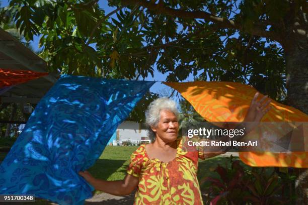 old aged pacific islander womqn waving hello / goodbye - pacific islander ethnicity stock-fotos und bilder