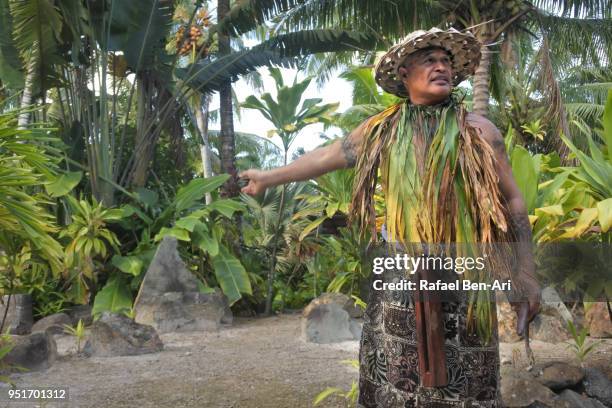pacific islander man explains about an ancient marae in rarotonga cook islands. - pacific islander ethnicity stock-fotos und bilder