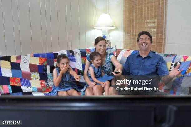 family watches tv together at home - rafael ben ari stock pictures, royalty-free photos & images