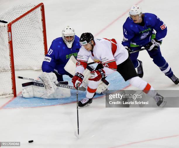 Gasper Kroselj of Slovenia, Balint Magosi of Hungary and Jan Drozg of Slovenia in action during the 2018 IIHF Ice Hockey World Championship Division...