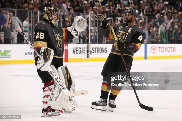 Goaltender Marc-Andre Fleury of the Vegas Golden Knights is congratulated by Pierre-Edouard Bellemare after defeating the San Jose Sharks in Game One...