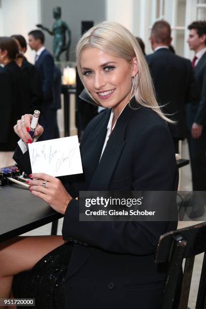 Lena Gercke, Brand Ambassador Montblanc writes with a filler during the 27th Montblanc de la Culture Arts Patronage Award at Residenz on April 26,...