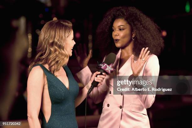 Natalie Morales and actress Gabrielle Union talk during the CinemaCon Big Screen Achievement Awards brought to you by the Coca-Cola Company at The...