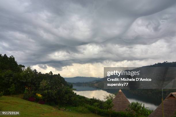stormy sky on lake bunyonyi - mammatus cloud stock pictures, royalty-free photos & images