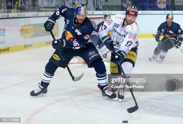 Konrad Abeltshauser of Red Bull Munich vies Jamie MacQueen of Eisbaeren Berlin during the DEL Playoff final match seven between EHC Red Bull Munich...