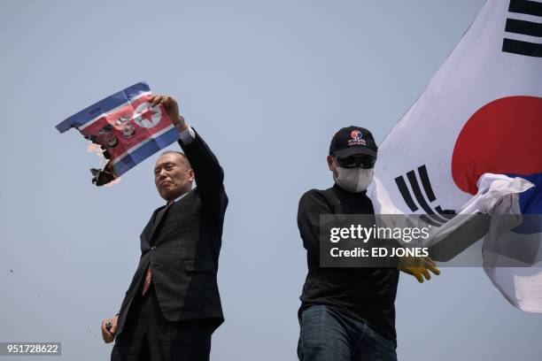 Anti-North Korea activists burn a North Korean flag during a demonstration at the Imjingak Peace Park near the Tongil bridge checkpoint leading to...