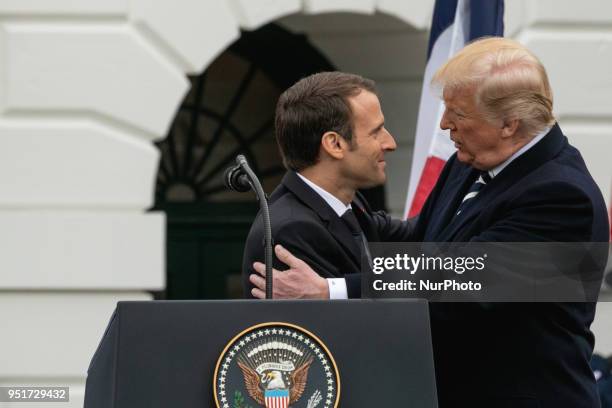 French President Emmanuel Macron, and U.S. President Donald Trump hug, at the arrival ceremony for President Macron on the South Lawn of the White...