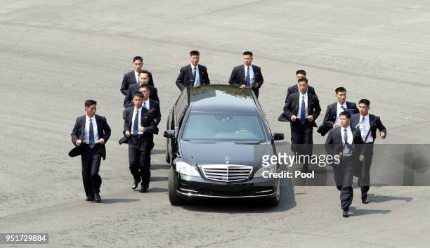 North Korean Leader Kim Jong Un heads to the north side for luncheon in the car escorted by North's bodyguards from the Peace House during the...