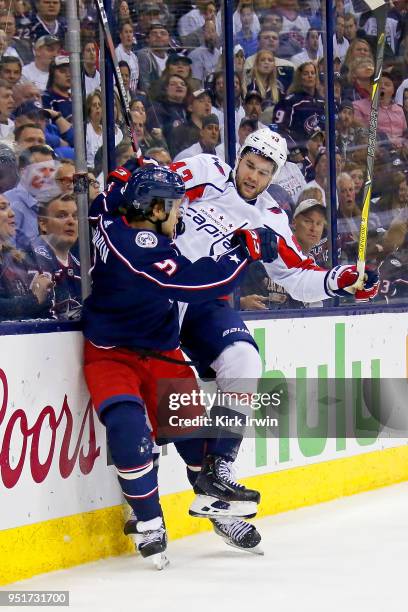 Artemi Panarin of the Columbus Blue Jackets collides with Tom Wilson of the Washington Capitals while chasing after the puck in Game Six of the...