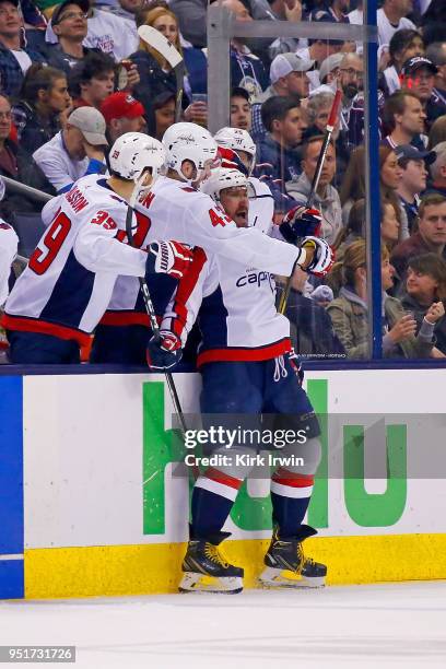 Alex Ovechkin of the Washington Capitals is congratulated by his teammates after scoring goal in Game Six of the Eastern Conference First Round...