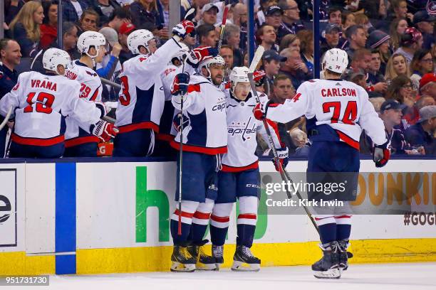 Alex Ovechkin of the Washington Capitals is congratulated by his teammates after scoring goal in Game Six of the Eastern Conference First Round...