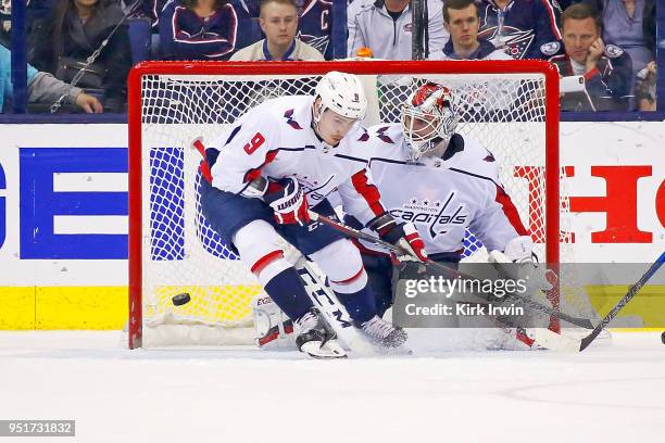 Dmitry Orlov of the Washington Capitals attempts to block the puck as Braden Holtby of the Washington Capitals makes a save in Game Six of the...