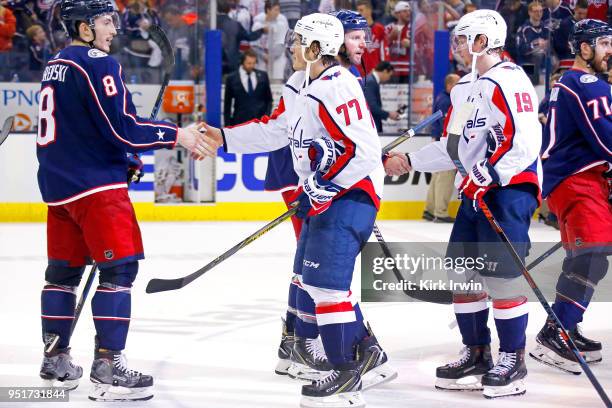 Zach Werenski of the Columbus Blue Jackets shakes hands with T.J. Oshie of the Washington Capitals after the end of Game Six of the Eastern...