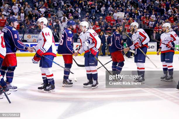 Players from the Columbus Blue Jackets and the Washington Capitals shake hands at the end of Game Six of the Eastern Conference First Round during...