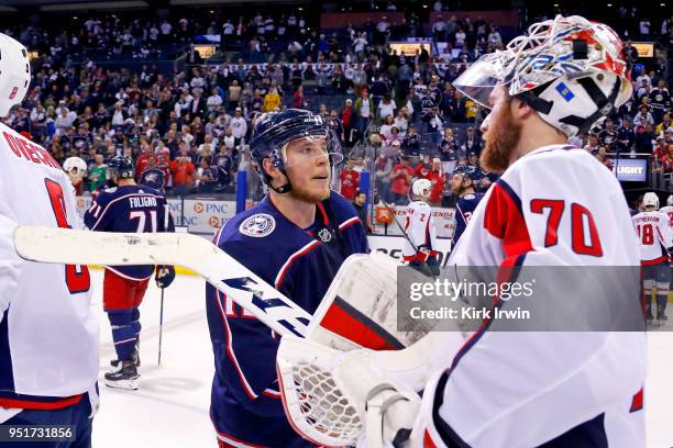 Cam Atkinson of the Columbus Blue Jackets shakes hands with Braden Holtby of the Washington Capitals at the end of Game Six of the Eastern Conference...