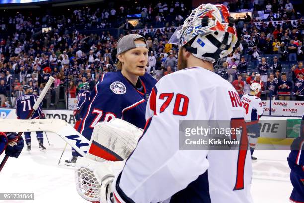 Joonas Korpisalo of the Columbus Blue Jackets shakes hands with Braden Holtby of the Washington Capitals at the end of Game Six of the Eastern...