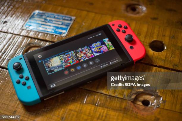 In this photo illustration, a turned on Nintendo Switch with 2 Joy-Con attached on it. The Kyoto based video game company Nintendo ended its comeback...