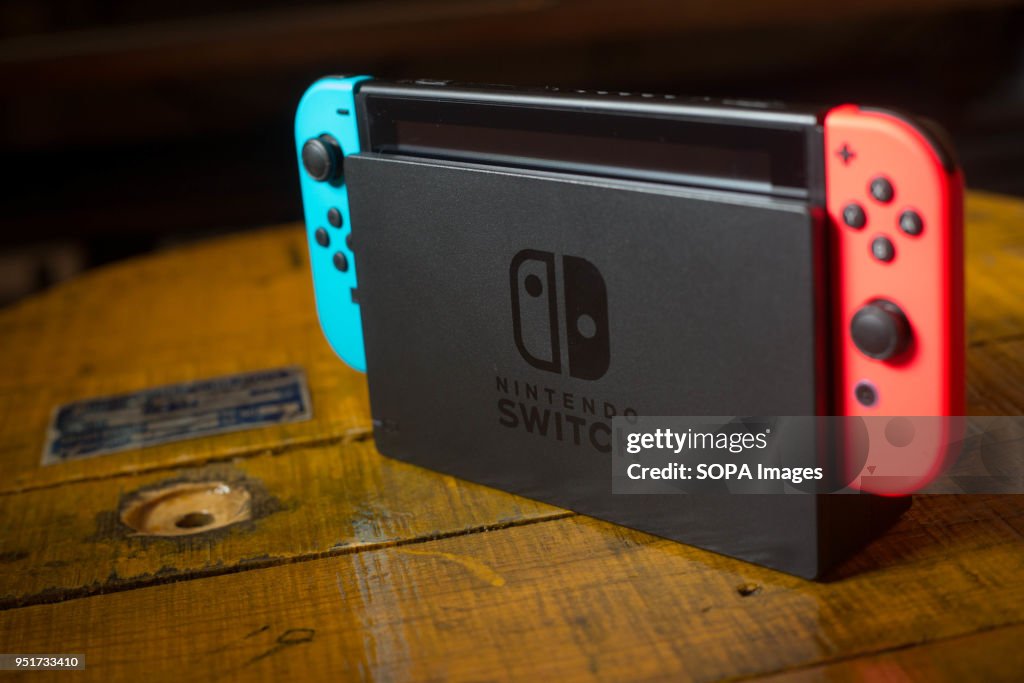 A Nintendo Switch on its Dock with 2 Joy-Con attached on it