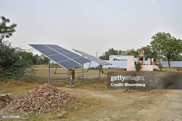 Solar panels installed to power a bore well stand in a village on the outskirts of Alwar, Rajasthan, India, on Tuesday, April 17, 2018. Rural...