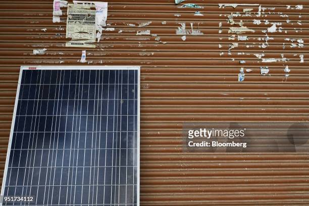 Solar panel rests against shutters in a village on the outskirts of Alwar, Rajasthan, India, on Tuesday, April 17, 2018. Rural electrification is a...