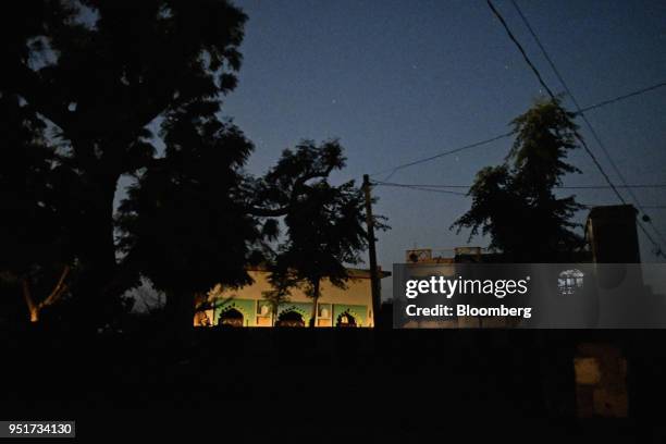 House is illuminated by a passing vehicle at night in a village on the outskirts of Alwar, Rajasthan, India, on Tuesday, April 17, 2018. Rural...