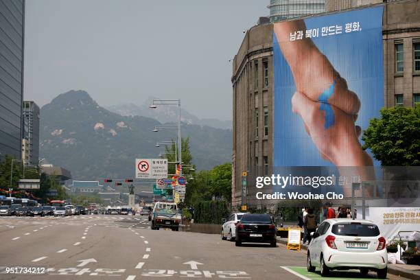 Seoul, SOUTH KOREA 27: An illustration banner celebrating Inter-Korean Summit is hanged on the wall of Seoul Library on April 27, 2018 in Seoul,...