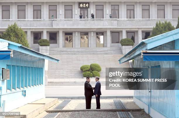 North Korea's leader Kim Jong Un shakes hands with South Korea's President Moon Jae-in at the Military Demarcation Line that divides their countries...