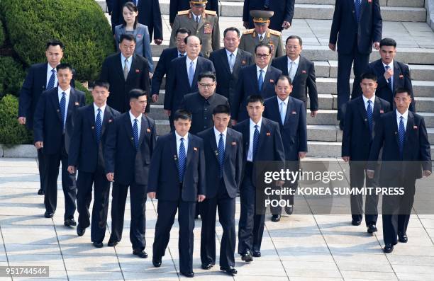 North Korea's leader Kim Jong Un is escorted by North Korean bodyguards as he walks from the North to the Military Demarcation Line that divides the...