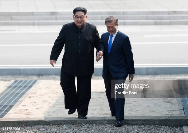 North Korean leader Kim Jong Un and South Korean President Moon Jae-in cross back the military demarcation line to the south side after Moon crossing...
