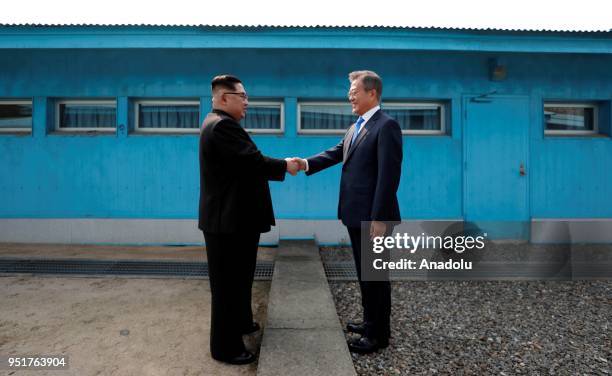 South Korean President Moon Jae-in and North Korean leader Kim Jong-un meet at the Military Demarcation Line of the truce village of Panmunjom, South...
