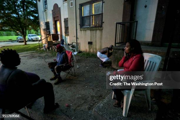 Some of the remaining residents gather in a courtyard of the Barry Farm housing complex on Saturday, August 12 in Washington, DC. The housing complex...