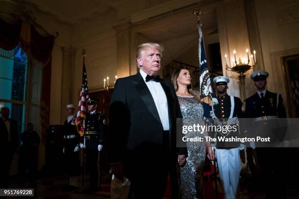 President Donald J. Trump and first lady Melania Trump walk out with French President Emmanuel Macron and his wife Brigitte Macron in the Grand Foyer...