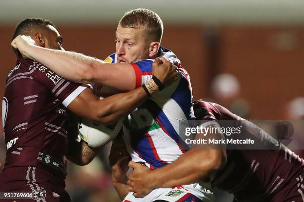 Mitchell Barnett of the Knights is tackled during the Round eight NRL match between the Manly-Warringah Sea Eagles and the Newcastle Knights at...