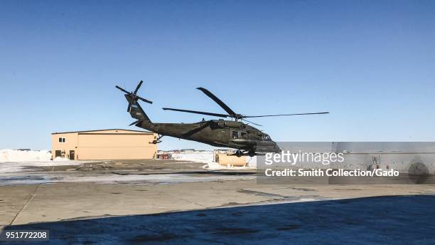 An Alaska Army National Guard UH-60 Blackhawk helicopter lifts off from its parking spot at the Ralph Wien Memorial Airport in Kotzebue, Alaska,...