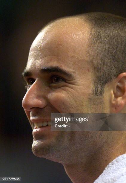 Andre Agassi smiles during his quarter-final match against Australian Mark Philippousis at the Paris-Bercy Open 05 November 1999. Agassi won 6-4,...