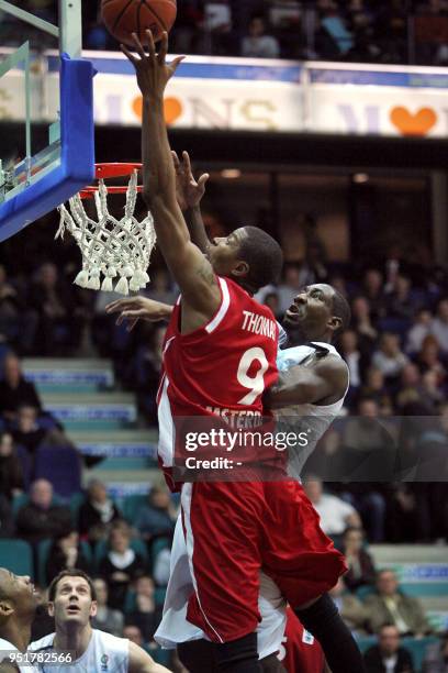 EclipseJet Amsterdam's Dutch Victor Thomas vies with Mons' US Kelvin Torbert during their Eurochallenge basketball match on March 10 in Mons. AFP...